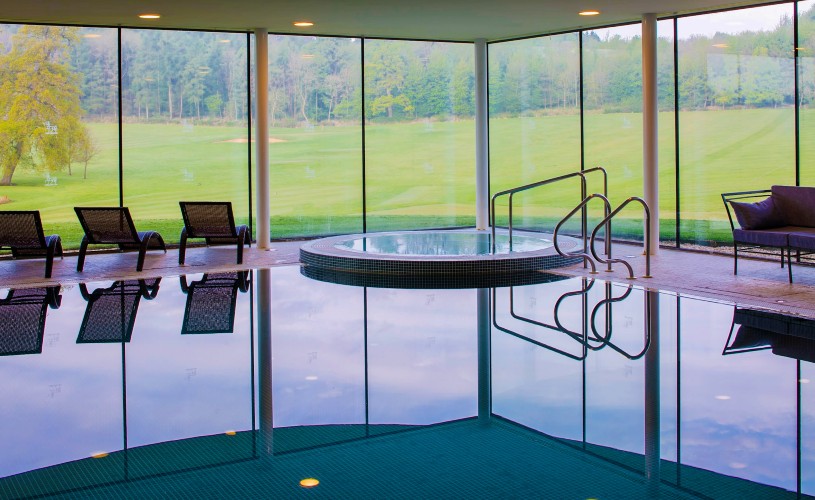 Indoor swimming pool looking out to golf course at Bowood Hotel